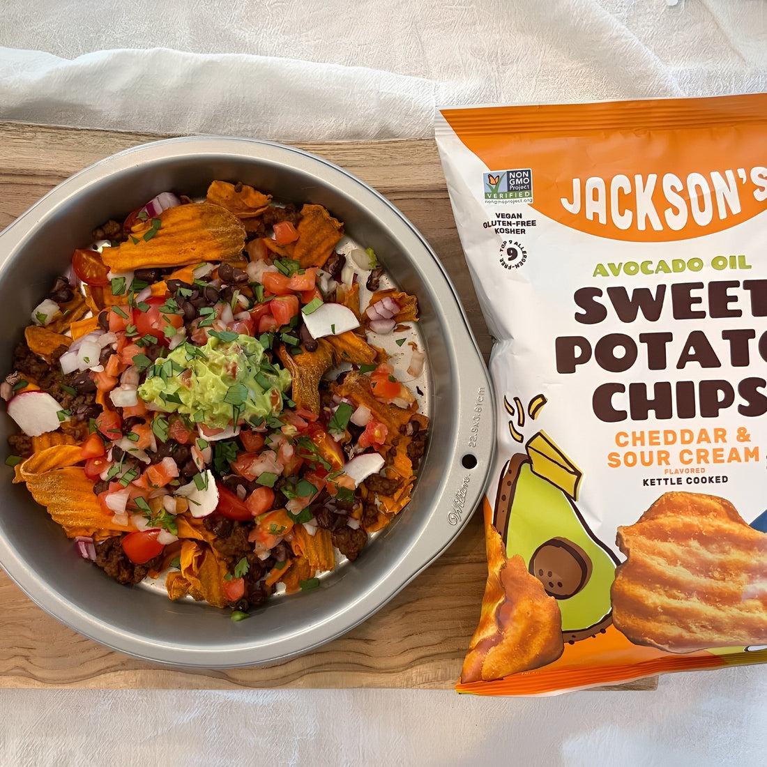 Plate of nachos with a bag of Jackson's next to it.