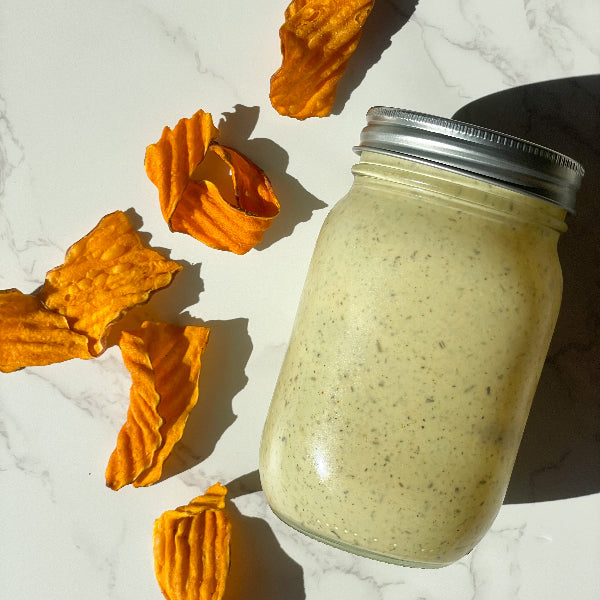 Mason jar filled with ranch and wavy chips on the side