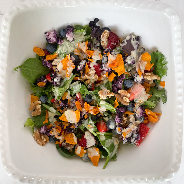 Berry salad in a bowl with Jackson's Sweet Potato Chips crushed over the top.