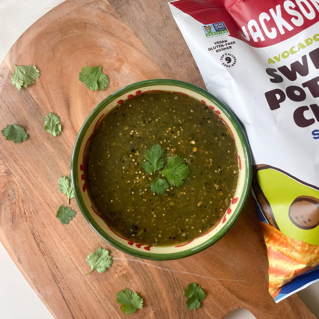 Bowl of salsa verde with bag of Jackson's to the right of it