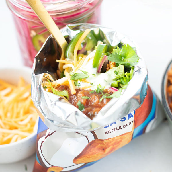 Walking taco: taco meat and additional toppings over a bag of Jackson's Sweet Potato Chips