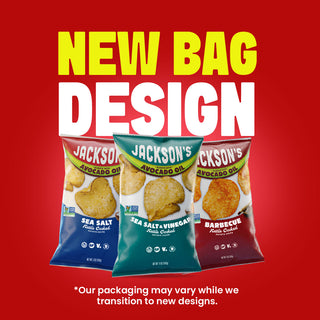 Three bags of Jackson's Avocado Oil potato chips shown against a bright red background with large yellow and white text reading 'NEW BAG DESIGN.' The bags are labeled Sea Salt, Sea Salt + Vinegar, and Barbecue flavors, and there is small text at the bottom noting that packaging may vary during the transition to new designs.