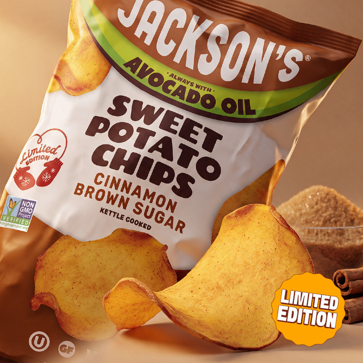 Jackson's Cinnamon Brown Sugar Sweet Potato Chip Front of Bag, limited edition, always with avocado oil, kettle cooked. Large chip in front of bag with a bowl of brown sugar and cinnamon sticks in the background.