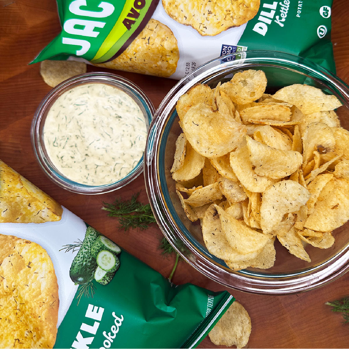Jackson's Limited Edition Dill Pickle Kettle Chip Cooked in Avocado Oil in a bowl with bags on the side
