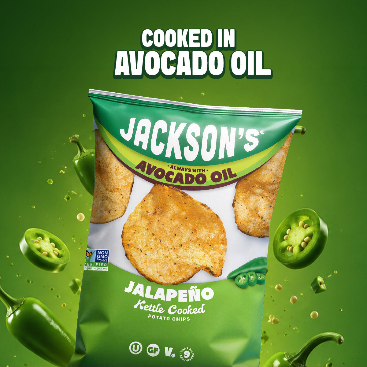 A bag of Jackson's Jalapeño Kettle Cooked Potato Chips on a green background with floating jalapeños and text reading 'COOKED IN AVOCADO OIL'.