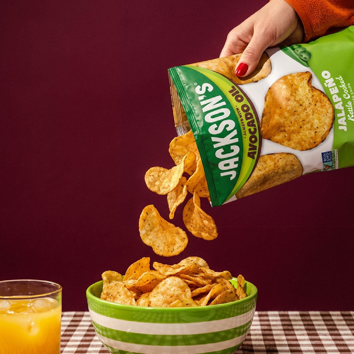 Jackson's jalapeno kettle chips poured into a bowl with chips flying around