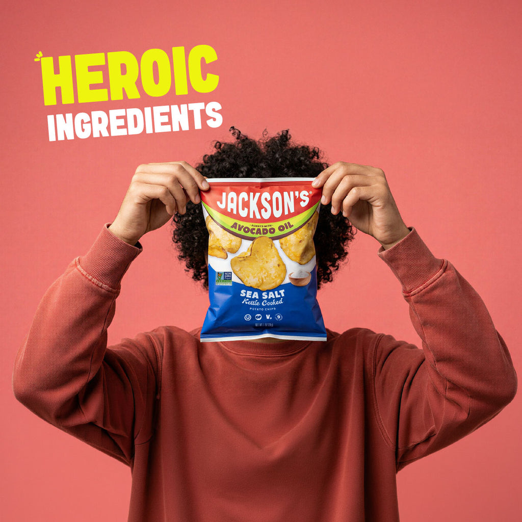 person holding a bag of jackson's kettle chips in front of their face with words heroic ingredients