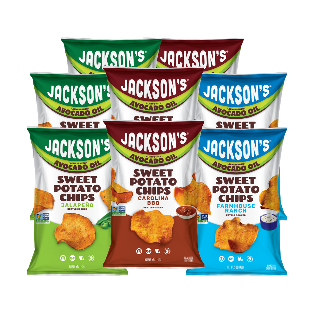 Six bags of Jackson's Sweet Potato Chips arranged in two rows on a plain white background. The front row includes a green Jalapeño bag, a brown Carolina BBQ bag, and a blue Farmhouse Ranch bag.